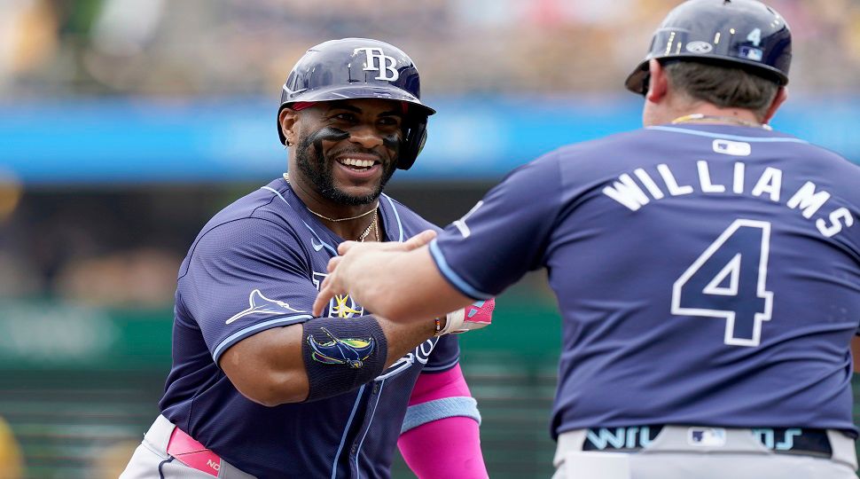 Tampa Bay Rays' Yandy Diaz, left, is greeted by third base coach Brady Williams, right, as he rounds the bases after hitting a home run during the first inning of a baseball game against the Pittsburgh Pirates, Sunday, June 23, 2024, in Pittsburgh. (AP Photo/Matt Freed)