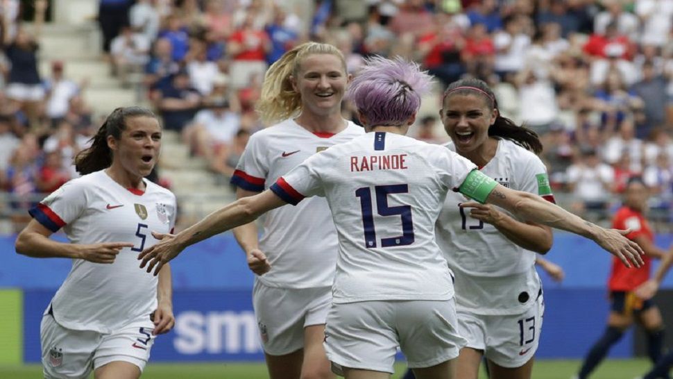 United States midfielder Megan Rapinoe celebrates with her teammates after scoring the opening goal off of a penalty kick in the 7th minute vs. Spain.  The Americans beat the Spaniards 2-1 and advanced to the quarterfinals of the Women's World Cup.  (AP Photo/Alessandra Tarantino)