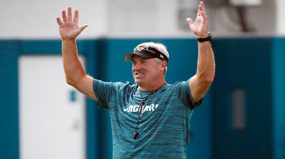 Jacksonville Jaguars head coach Doug Pederson jokes with players as he signals a touchdown during a pass drill at the team's NFL football practice, Tuesday, June 11, 2024, in Jacksonville, Fla. (AP Photo/John Raoux)