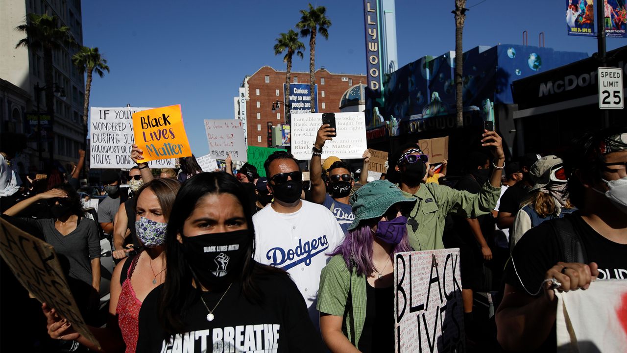 Demonstrators march Sunday June, 7, 2020 in the Hollywood area of Los Angeles, during a protest over the death of George Floyd who died May 25 after he was restrained by Minneapolis police. (AP Photo/Marcio Jose Sanchez)