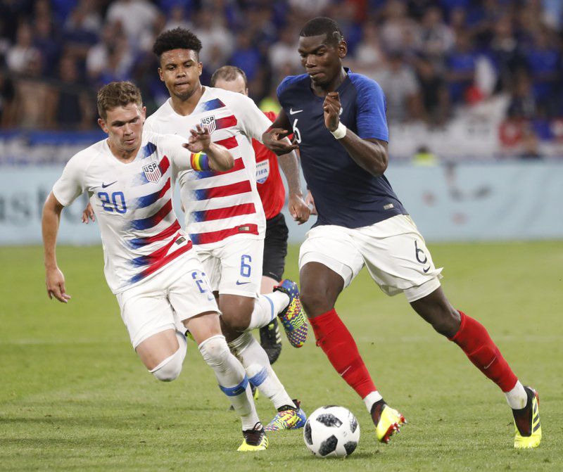France’s Paul Pogba, right, battles for the ball with United States’ Will Trapp, left, and Weston McKennie during a friendly soccer match between France and USA.  (AP Photo/Lauren Cipriani)