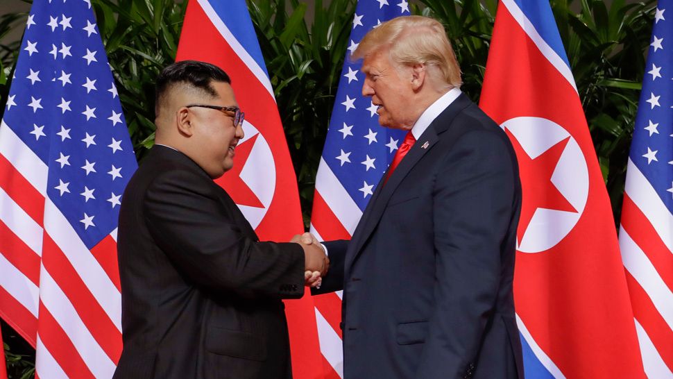 U.S. President Donald Trump shakes hands with North Korea leader Kim Jong Un at the Capella resort on Sentosa Island Tuesday, June 12, 2018 in Singapore. (AP Photo/Evan Vucci)