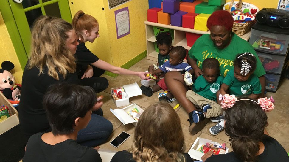 Volunteers from The Kind Mouse bring snack boxes to children at the Delores M. Smith Academy in St. Petersburg, Wednesday, June 20, 2018. (Melissa Eichman, staff)