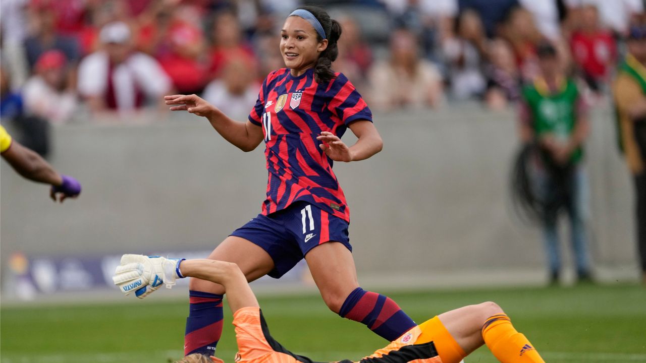 U.S. forward Sophia Smith, back, reacts after scoring a goal against Colombia goalie Catalina Perez during the second half of an international friendly soccer match Saturday, June 25, 2022, in Commerce City, Colo. (AP Photo/David Zalubowski)