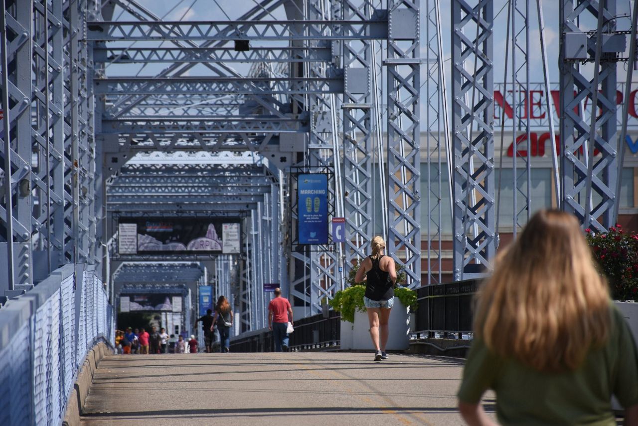 A person runs for exercise across the Purple People Bridge. The pedestrian bridge is a popular option for hundreds of bicyclists, walkers and runners on days with decent weather (Spectrum News/Casey Weldon)