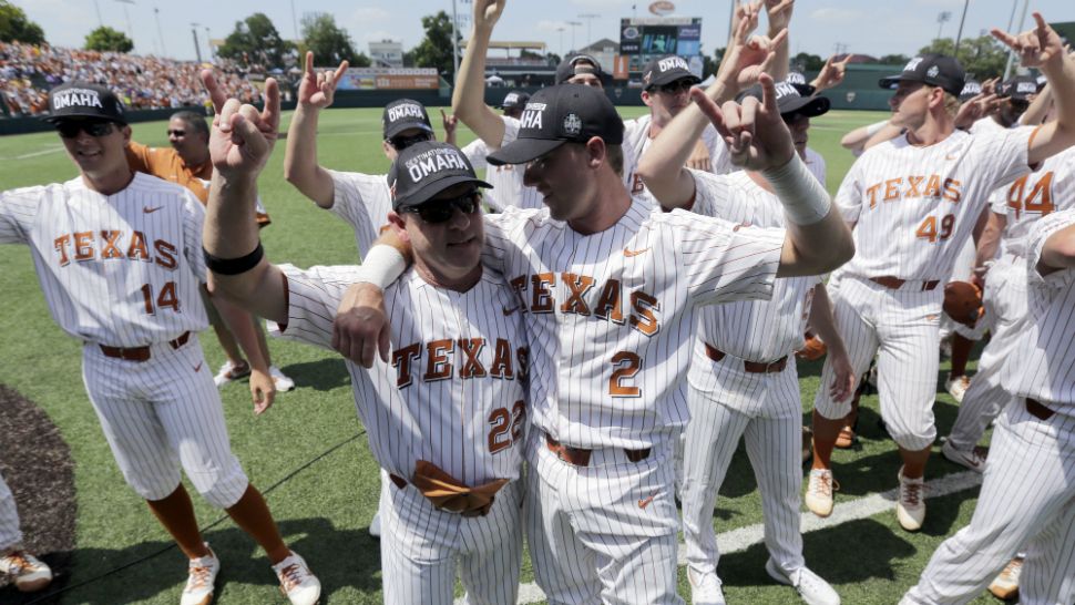 Texas infielder Kody Clemens (2) celebrates with head coach David Pierce (22) and teammates following their win over Tennessee Tech in an NCAA college super regional baseball game, Monday, June 11, 2018, in Austin, Texas. Texas won 5-2. (AP Photo/Eric Gay)