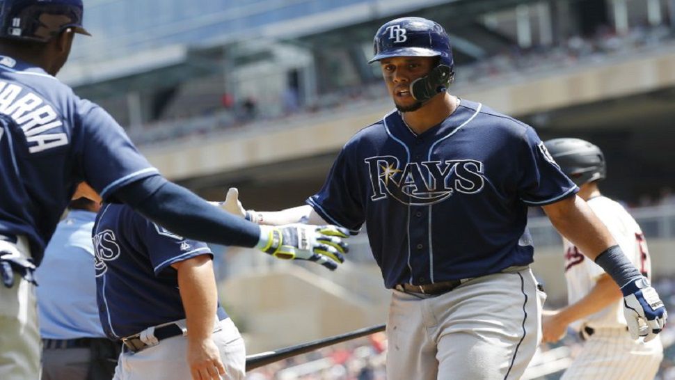 Rays outfielder Carlos Gomez, right, is congratulated by Adeiny Hechavarria after scoring on a ground-rule double by Malex Smith during the fourth inning of the Rays' 19-6 win over the Twins.  (AP Photo/Jim Mone)