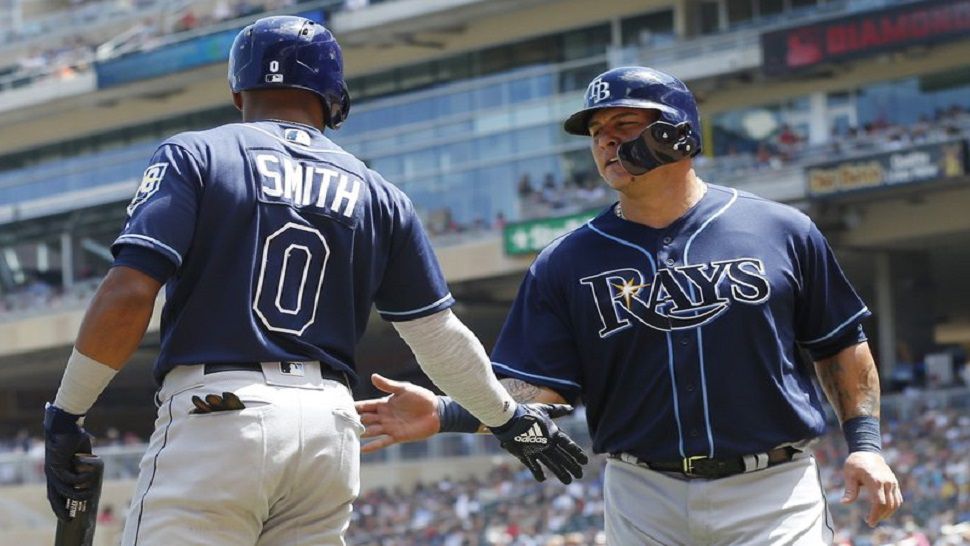 Wilson Ramos, right is greeted by Malex Smith after scoring on a double by Carlos Gomez off Minnesota Twins pitcher Jose Berrios in the Rays 19-6 win over the Twins on Saturday.  (AP Photo/Jim Mone)