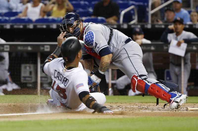 Rays catcher Wilson Ramos tags out Starlin Castro at home in 4th inning of Monday's game vs. the Marlins.  The Rays rallied to tie the game at 2 in the 9th, but fell to Marlins in 10 innings in Miami.  (AP Photo/Wilfredo Lee)