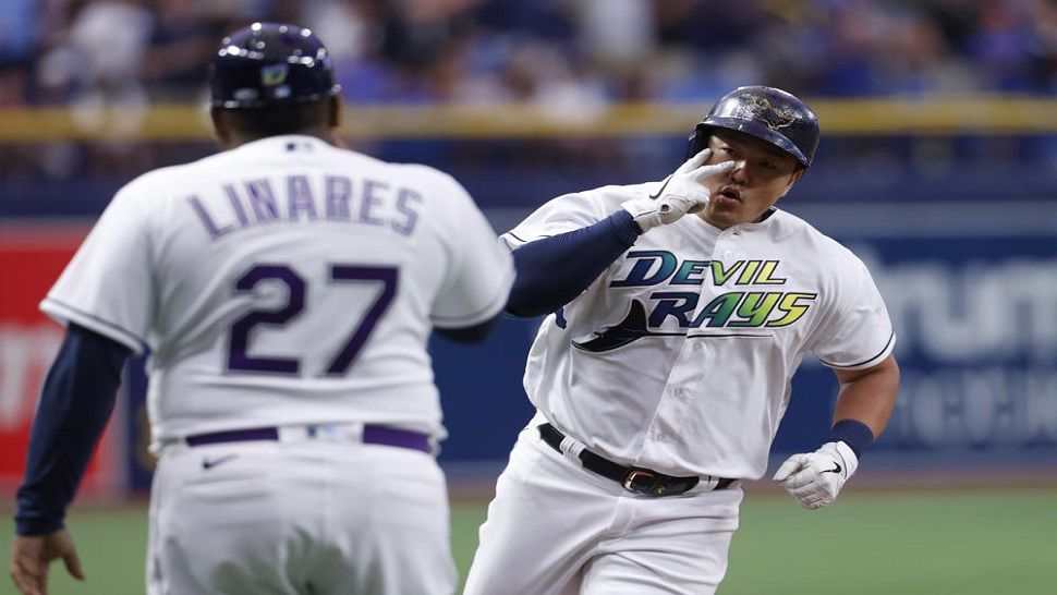 Tampa Bay Rays' Ji-Man Choi celebrates with third base coach Rodney Linares after hitting a home run against the Boston during the first inning of the Rays' 9-5 win over the Red Sox.  Tampa Bay has reclaimed first place in the American League East. (AP Photo/Scott Audette)