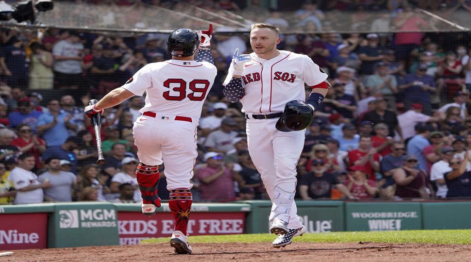 Boston Red Sox's Trevor Story, right, is congratulated by Christian Arroyo (39) after hitting a solo home run during the fourth inning of a baseball game against the Tampa Bay Rays at Fenway Park, Monday, July 4, 2022, in Boston. (AP Photo/Mary Schwalm)