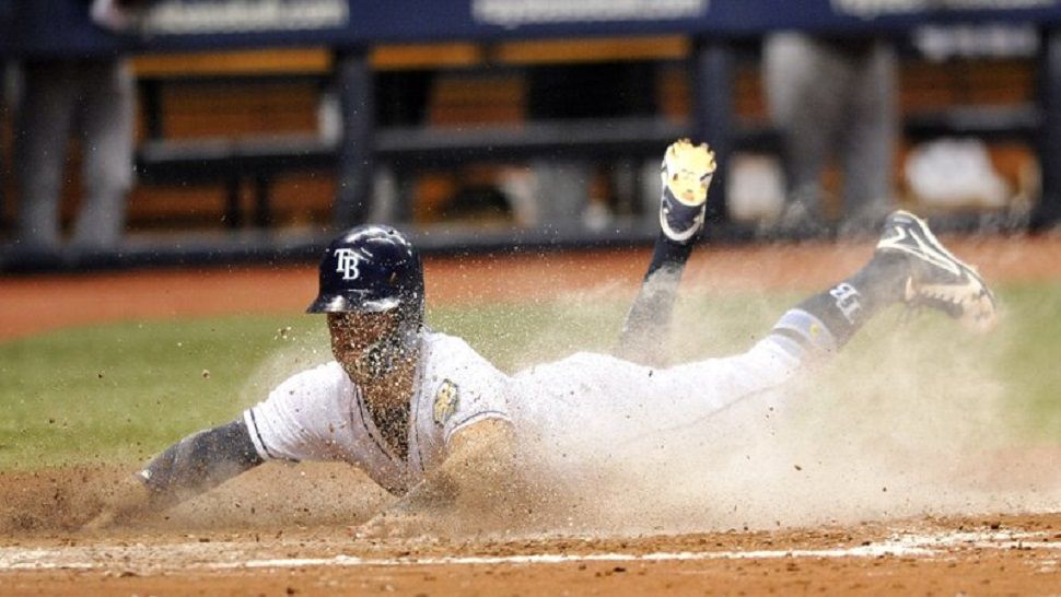 Rays pinch runner Johnny Field scores on Carlos Gomez's bunt single in the 7th inning of the Rays' 10-9 win over the Tigers.  (AP Photo/Steve Nesius)