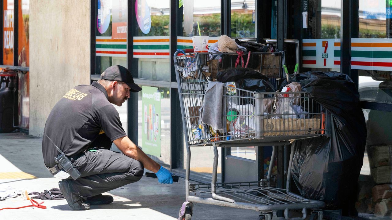 Officials investigate after officers found two victims with gunshot wounds following a robbery at a 7-Eleven in La Habra, Calif., on Monday, July 11, 2022.(Paul Bersebach/The Orange County Register via AP)