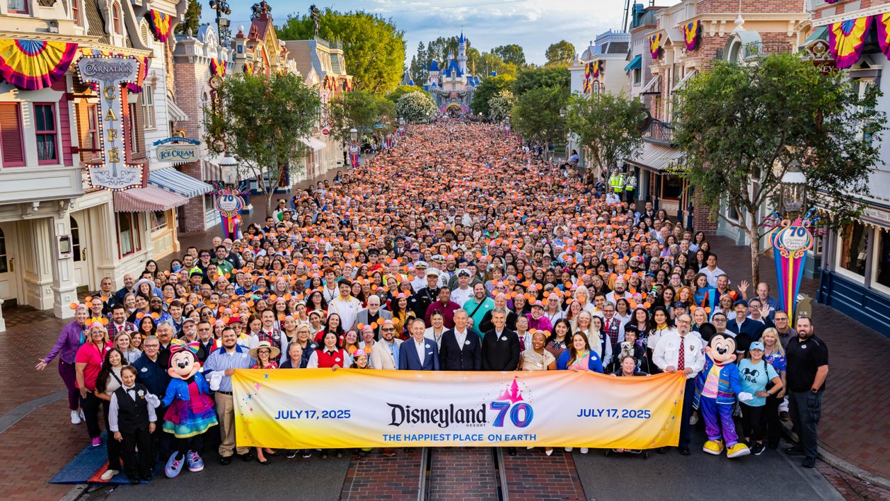 In honor of the Disneyland Resort 70th Celebration, The Walt Disney Company CEO Bob Iger, Disney Experiences Chairman Josh D’Amaro and Disneyland Resort President Thomas Mazloum pose with thousands of cast members on Main Street, U.S.A., in Disneyland Park in Anaheim, Calif. on July 17, 2025. (Disneyland Resort/Christian Thompson)