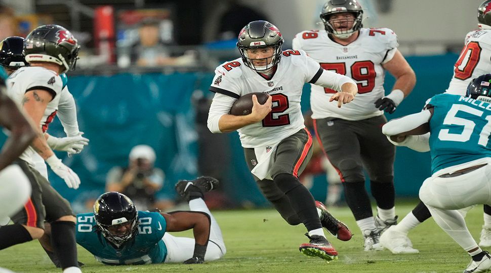 Tampa Bay Buccaneers quarterback Kyle Trask (2) looks for running room during a preseson NFL football game against the Jacksonville Jaguars Aug. 17, 2024, in Jacksonville, Fla. (AP Photo/John Bazemore)