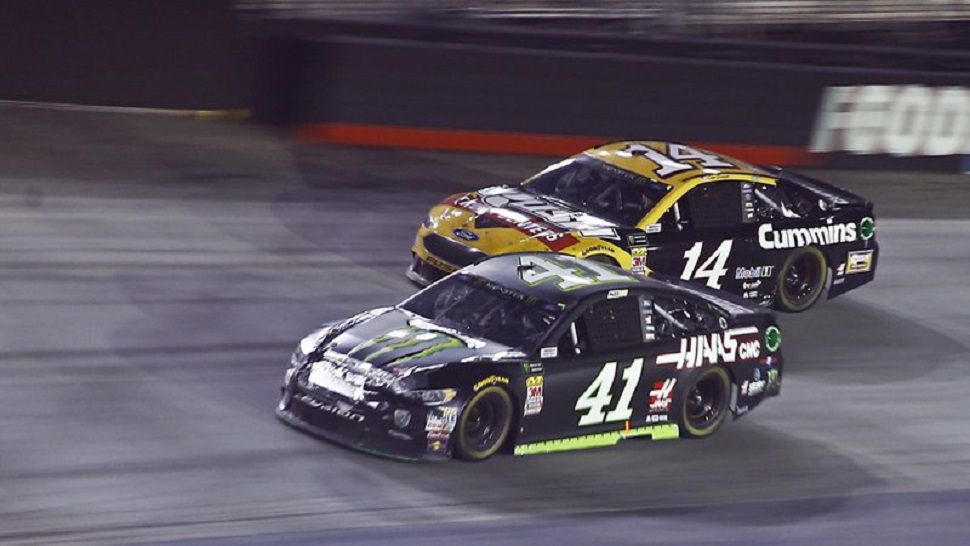 Kurt Busch (41) drives below Clint Bowyer Jr. during the NASCAR Cup Series auto race in Bristol, Tenn. Busch snapped a 58-race winless streak.  (AP Photo/Wade Payne)