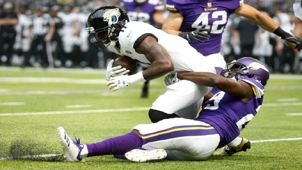 Jacksonville Jaguars wide receiver Marqise Lee is tackled by Minnesota Vikings defensive back Xavier Rhodes, right, during the first half of Jacksonville's 14-10 win over Minnesota on Saturday. (AP Photo/Bruce Kluckhohn)