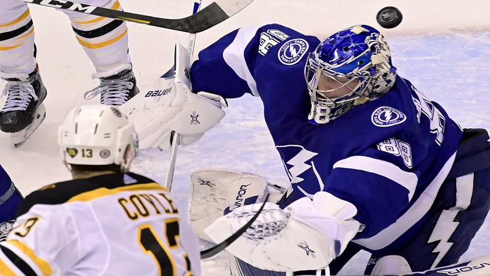 Lightning goalie gets beaten off a deflection by Charlie Coyle for Boston's first goal in Game 1 of the Eastern Conference Semifinals.  The Bruins opened a 3-0 lead and held off Tampa Bay's rally to win 3-2.  (Frank Gunn/The Canadian Press via AP)