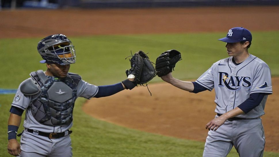 Rays catcher Mike Zunino, left, congratulates pitcher Ryan Yarbrough after the fifth inning of the Rays' 2-0 win over the Marlins on Friday night. (AP Photo/Wilfredo Lee)