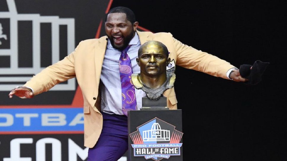 Former Baltimore Ravens linebacker Ray Lewis dances beside his bust as he delivers his induction speech at the Pro Football Hall of Fame Saturday, Aug. 4, 2018, in Canton, Ohio (AP Photo/David Richard)