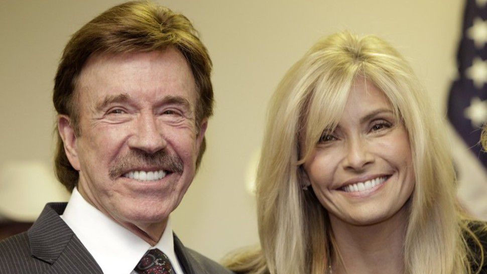 FILE - In this Dec. 2, 2010 file photo, actor Chuck Norris, left, and his wife Gena pose for a photo following a ceremony in Garland, Texas. (AP Photo/Tony Gutierrez, File)