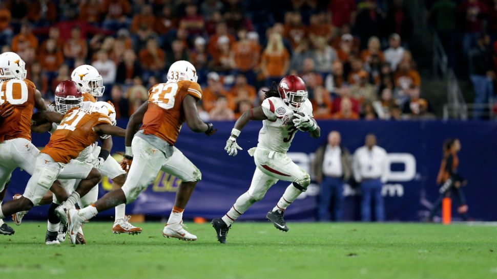 Arkansas Razorbacks running back Alex Collins (3) rushes for a gain during the Texas Bowl NCAA college football game against the Texas Longhorns at NRG Stadium on Monday, December 29, 2014 in Houston, Texas. Arkansas won 31-7. (AP Photo/Aaron M. Sprecher)