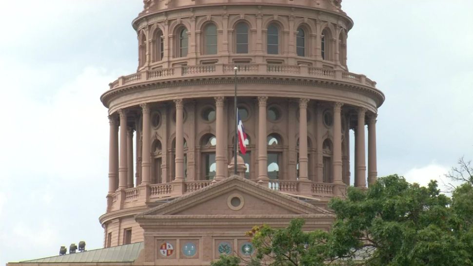 The Texas flag flies at half-staff in front of the Capitol building (Spectrum News footage)