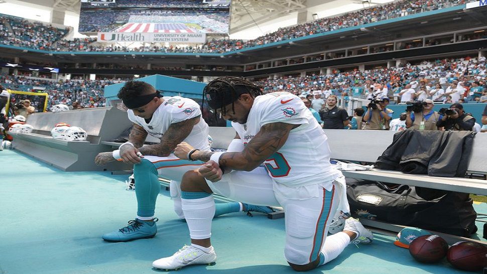 Miami Dolphins wide receivers Kenny Stills (10) and Albert Wilson (15) kneel during the national anthem before their Week 1 game against the Tennessee Titans. (AP Photo/Wilfredo Lee)
