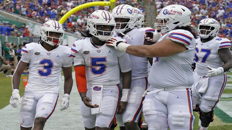 Florida quarterback Emory Jones (5) celebrates with teammates after his touchdown run against USF during the first half of the Gators' 42-20 win last Saturday. (AP Photo/Chris O'Meara)