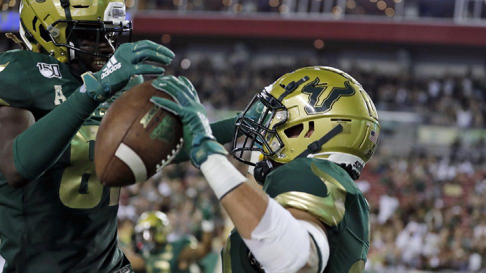 USF tight end Mitchell Wilcox, right, celebrates with wide receiver Kevin Purlett after one of his two TD receptions vs. South Carolina State.  (AP Photo/Chris O'Meara)