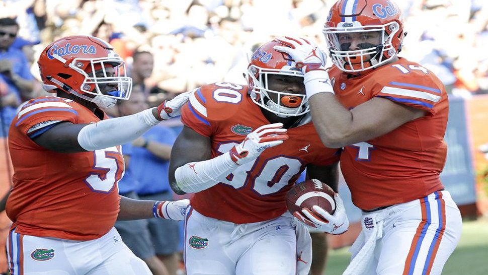 Clearwater Calvary Christian graduate and Florida Gators freshman Amari Burney (30) celebrates with Lakeland native Ventrell Miller, left, and tight end Lucas Kull, right, after he blocked a Colorado State punt that led to a Florida touchdown in the Gators 48-10 win in Gainesville. (AP Photo/John Raoux)