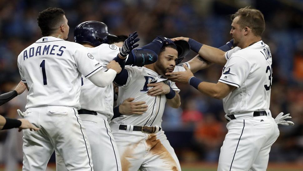 Rays outfielder Tommy Pham, second from right, celebrates his walk-off RBI single that scored Joey Wendle and gave the Rays a 5-4 win over Baltimore on Monday.  (AP Photo/Chris O'Meara)