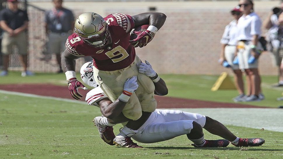 Florida State RB Jacques Patrick is tackled by Northern Illinois’ Jalen Embry in the first quarter of the Seminoles 37-19 win. (AP Photo/Steve Cannon)