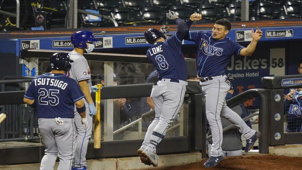 Tampa Bay's Brandon Lowe (8) celebrates with teammate Willy Adames, right, after Lowe's two-run home run in the 8th inning of the Rays' 8-5 win over the Mets.  With the win, Tampa Bay clinched their first American League East title since 2010.  (AP Photo/Frank Franklin II)