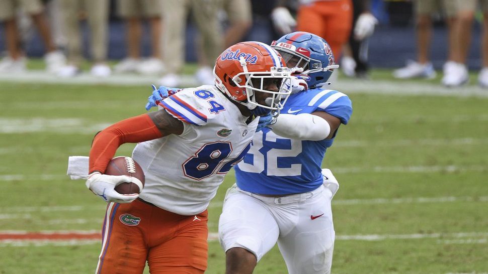Florida tight end Kyle Pitts (84) breaks away from Ole Miss linebacker Jacquez Jones (32) en route to a 71-yard touchdown reception thrown by Kyle Trask.  (AP Photo/Thomas Graning)