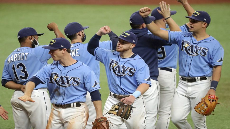 Tampa Bay Rays players celebrate after Sunday's regular season finale win over the Phillies. The top-seeded Rays host the Toronto Blue Jays in a best-of-three wild card series at Tropicana Field, beginning on Tuesday. (AP Photo/Mike Carlson)