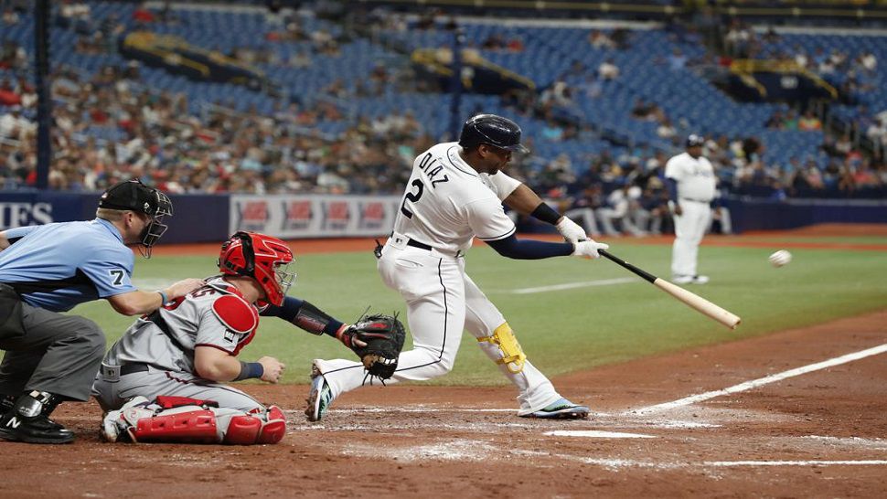 Tampa Bay Rays' Yandy Diaz (2) hits a three-run home run against the Minnesota Twins during the second inning the Rays' 11-4 win.  It was one of a franchise record-tying six home runs on the day. (AP Photo/Scott Audette)