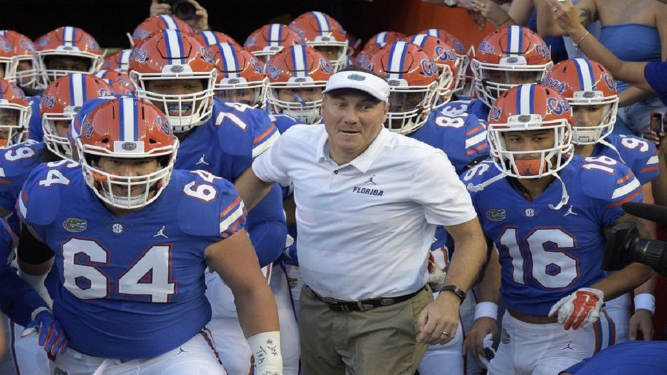 Florida head coach Dan Mullen, center, runs onto the field with his players before their game against Charleston Southern. No. 25 Florida (1-0) is seeking its 32nd consecutive victory against Kentucky (1-0) when the teams open SEC play in the Swamp on Saturday. It’s the longest active streak in an uninterrupted series and the fourth-longest in NCAA history. (AP Photo/Phelan M. Ebenhack, File)