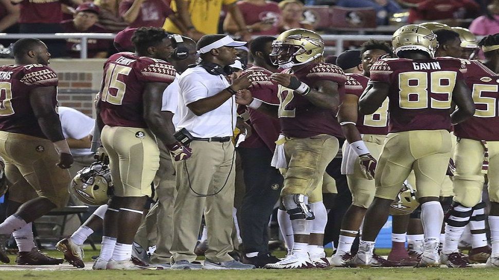 Florida State head coach Willie Taggart, center, talks with quarterback Deondre Francois during the fourth quarter FSU's 36-26 win over Samford. (AP Photo/Steve Cannon)