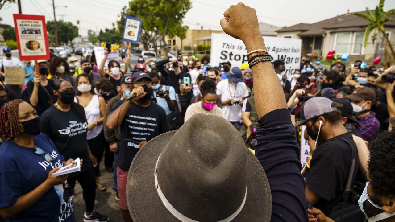 Hundreds of protesters gather before a rally around the neighborhood where Dijon Kizzee lived and died in Los Angeles, Sept. 12, 2020. (AP Photo/Jintak Han)