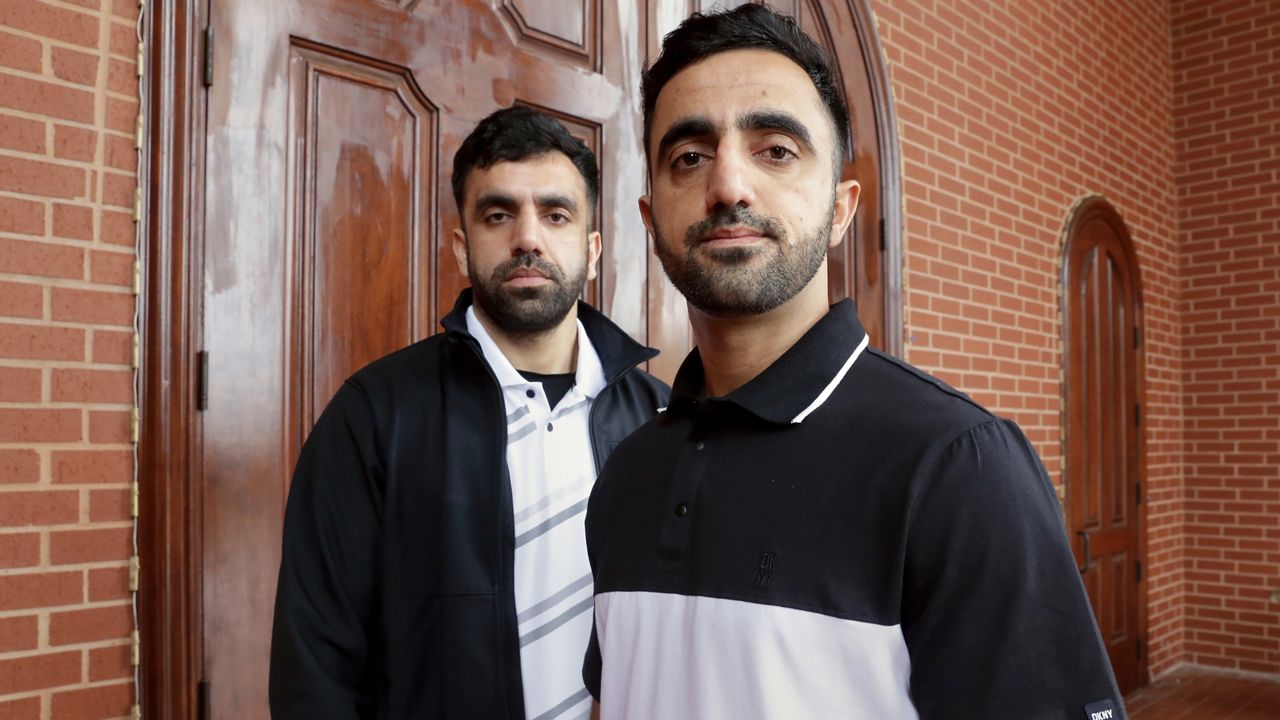 Brothers Samiullah Safi, left, and Abdul Wasi Safi pose for a picture after Friday prayers outside the Al-Noor Society Mosque, April 7, 2023, in Houston. Abdul Wasi Safi, an Afghan soldier who fled the Taliban and traveled through nearly a dozen countries before being arrested at the Texas-Mexico border and detained for months, has been granted asylum, allowing him to remain in the United States, his brother said Wednesday, Sept. 13. (AP Photo/Michael Wyke, File)
