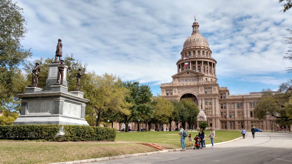 People stand outside of the Texas Capitol (Photograph: Josh Kleinstreuer)
