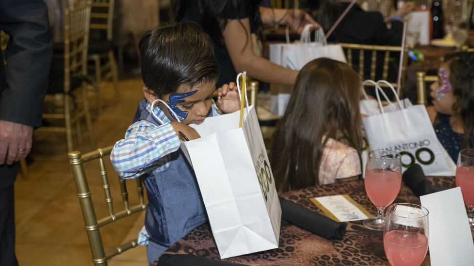 A child looks into his swag bag at the San Antonio Zoo. (Photo credit: San Antonio Zoo)