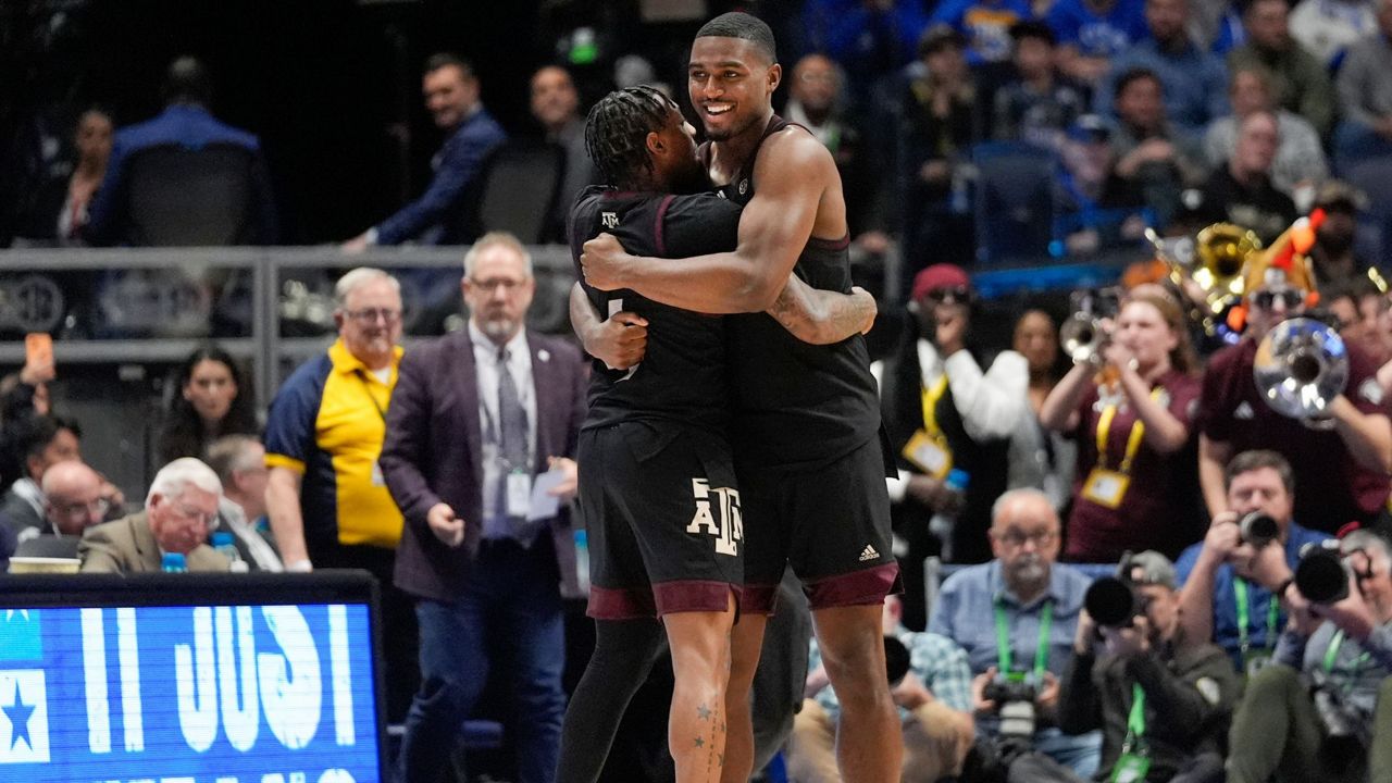 Texas A&M's Wade Taylor IV (4) and Henry Coleman III (15) embrace after defeating Kentucky in an NCAA college basketball game at the Southeastern Conference tournament Friday, March 15, 2024, in Nashville, Tenn. (AP Photo/John Bazemore)