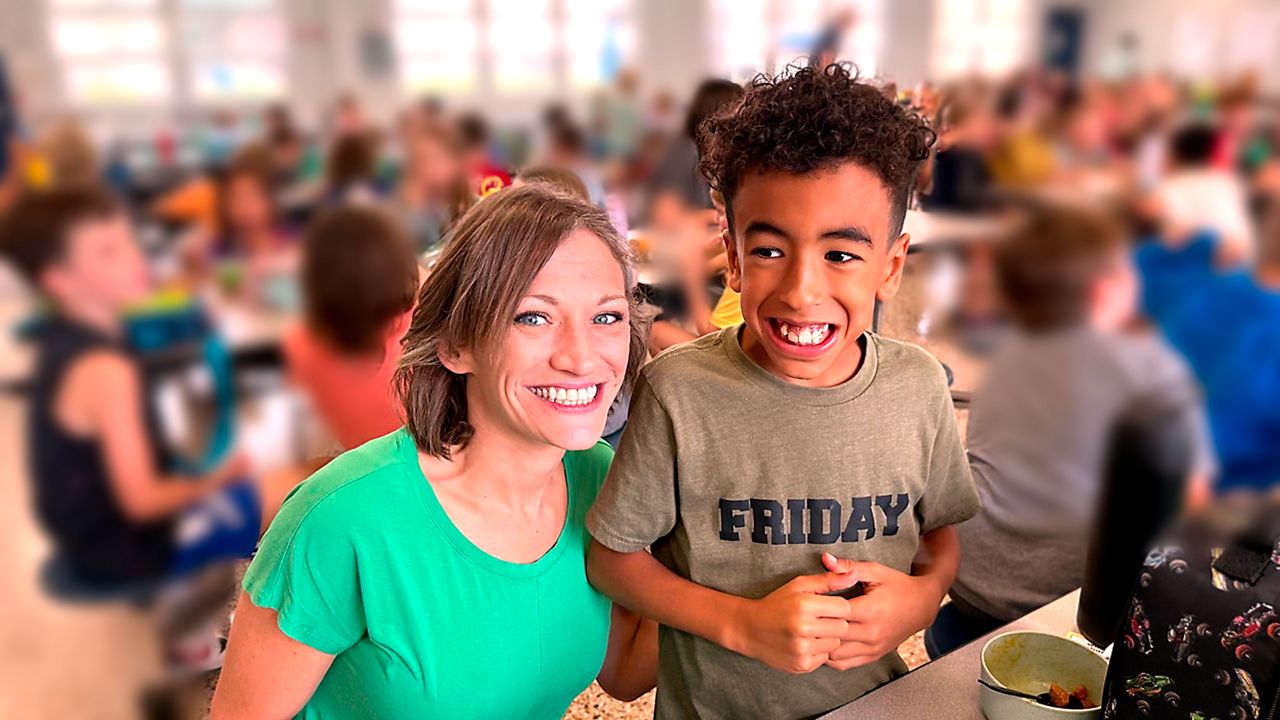 Tamara Perez's son, Grayson, who was diagnosed with autism at 3 years old, stands next to his ABA therapist at school. (Photo courtesy of Tamara Perez)