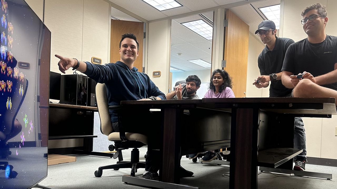 Assistant Professor Peter Washington and his research group test out a diagnostic video game. (Photo courtesy of the University of Hawaii/Anthony Peruma)