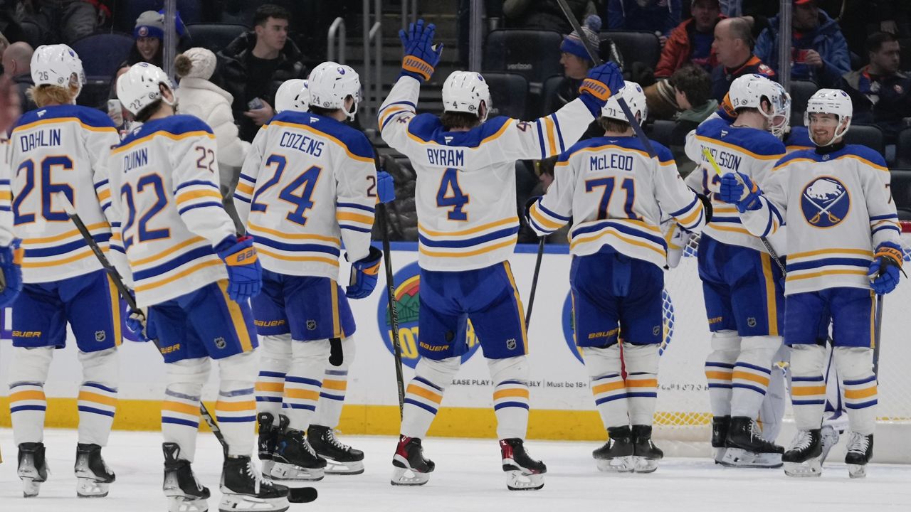 The Buffalo Sabres celebrate after an NHL hockey game against the New York Islanders Monday, Dec. 23, 2024, in Elmont, N.Y. (AP Photo/Frank Franklin II)