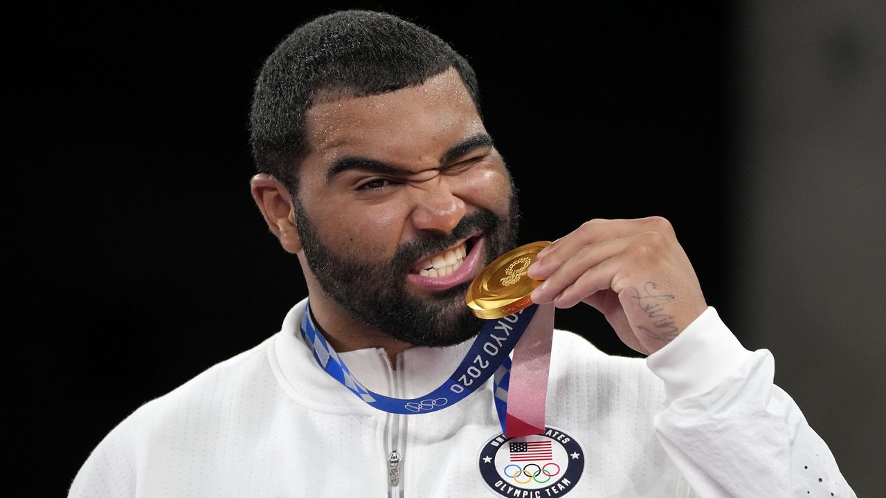 FILE - United State's Gable Dan Steveson poses with his gold medal during the medal ceremony for the men's freestyle 125kg wrestling at the 2020 Summer Olympics, in Chiba, Japan, Aug. 6, 2021. Olympic gold medal wrestler Gable Steveson is trading the mat for the gridiron by signing contract with the Buffalo Bills on Friday, May 31, 2024. (AP Photo/Aaron Favila, File)