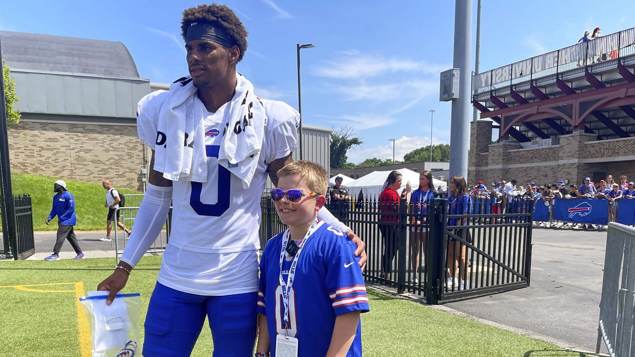 Buffalo Bills rookie receiver Keon Coleman meets with 10-year-old fan Logan Bittner following the team's NFL football training camp in Pittsford, N.Y., Tuesday, July 30, 2024. Coleman received a thank you card and another set of friendship bracelets Bittner made for the receiver. (AP Photo/John Wawrow)