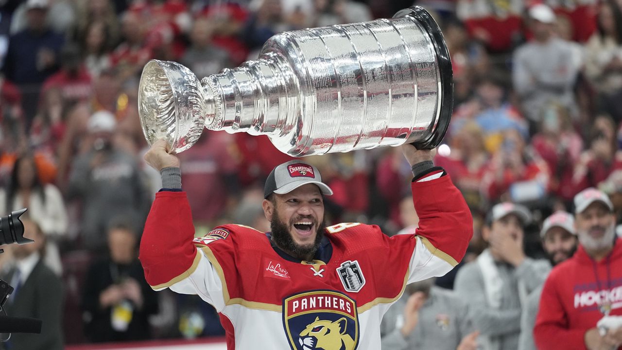 Florida Panthers right wing Kyle Okposo raises the NHL hockey Stanley Cup trophy after defeating the Edmonton Oilers, Monday, June 24, 2024, in Sunrise, Fla. (AP Photo/Wilfredo Lee)